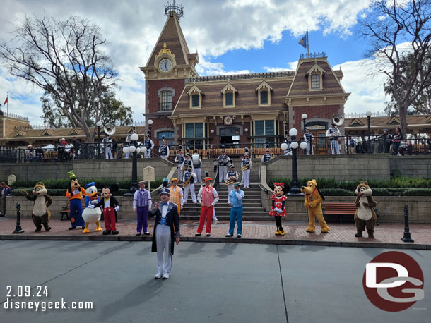 The Dapper Dans and characters with the Disneyland Band in Town Square