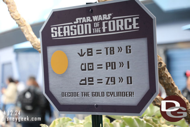 To celebrate Season of the Force there is a seek and find game.  Throughout Tomorrowland are six of these decoding signs for the game.