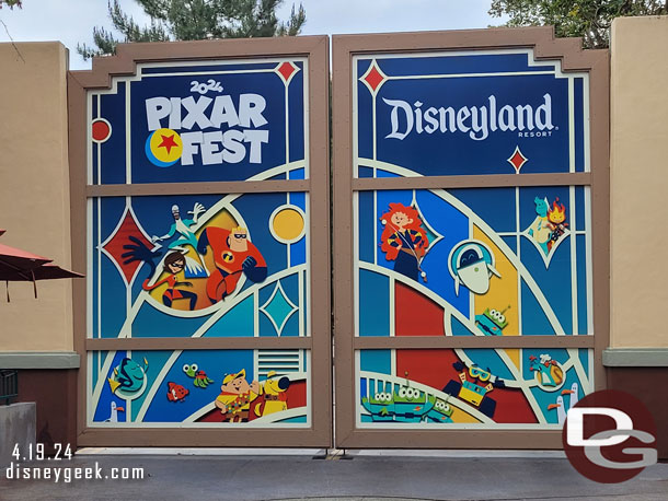 A Pixar Fest 2024 photo op/poster on the backstage gate near World of Disney