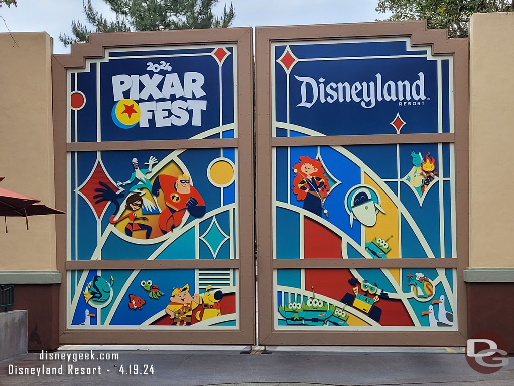 A Pixar Fest 2024 photo op/poster on the backstage gate near World of Disney