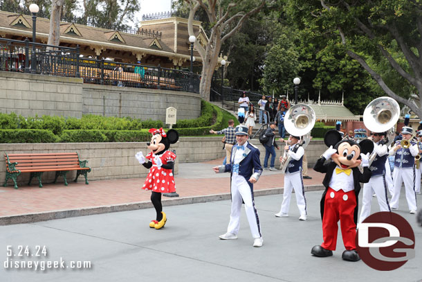 Mickey Mouse and Minnie Mouse lead the Disneyland Band into Town Square