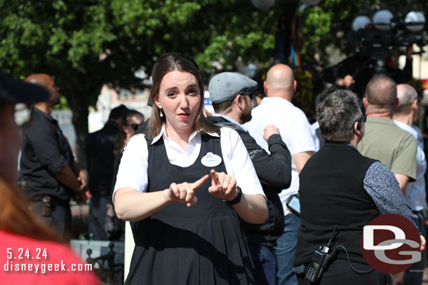 A cast member signing near by.