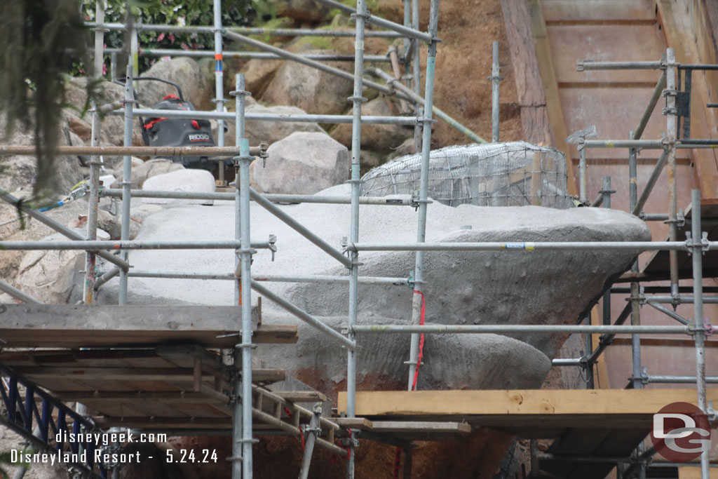 This section of rock work is moving along. The first layer of concrete is being applied to some of it.