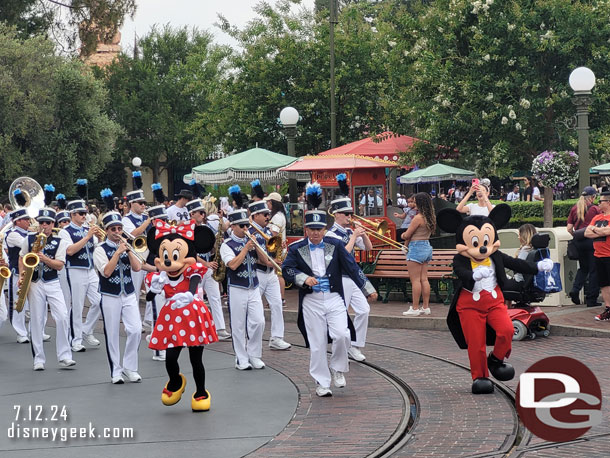 Mickey Mouse and Minnie Mouse leading the Disneyland Band and characters to Town Square