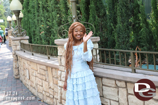 Ariel was standing along the walkway in the small world mall area.