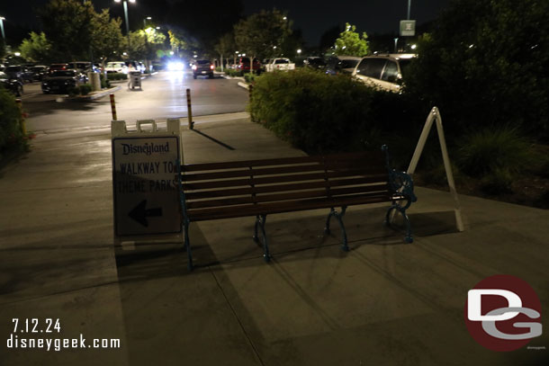 A-frames and a bench trying to convince you to stay on the walkway and not cut through parking lot.