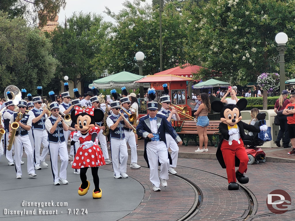 Mickey Mouse and Minnie Mouse leading the Disneyland Band and characters to Town Square