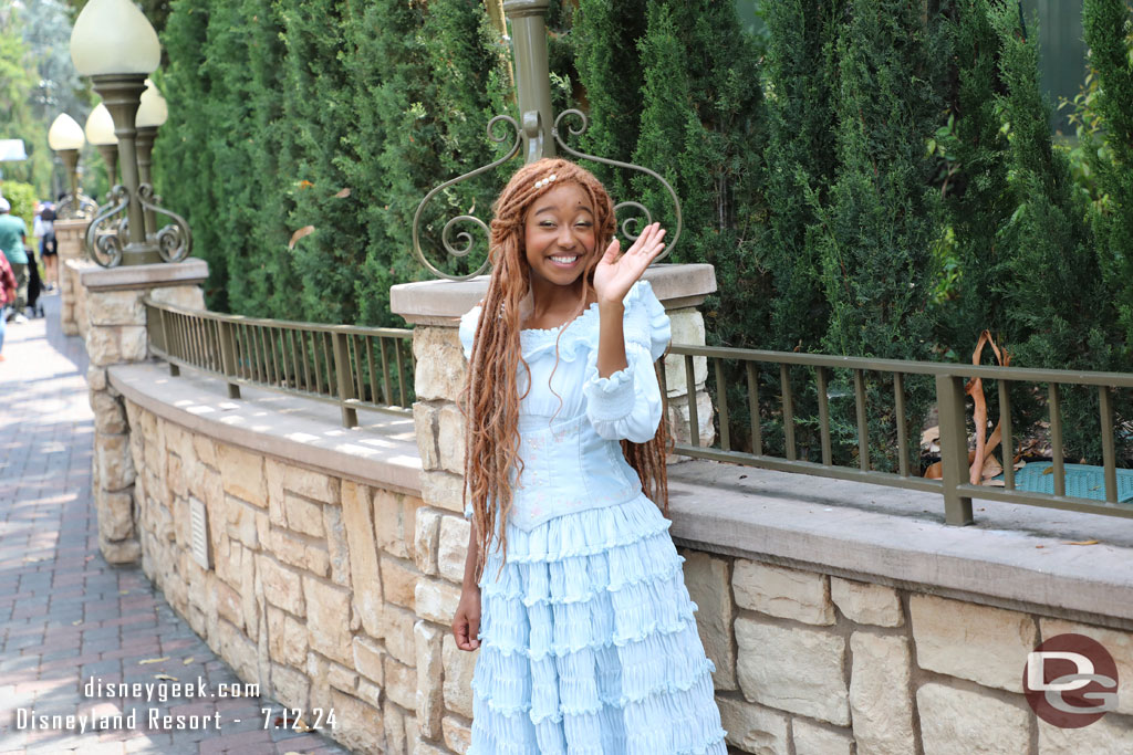 Ariel was standing along the walkway in the small world mall area.