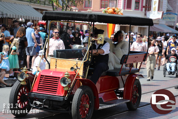 Bringing up the rear is the red horseless carriage with Cruella onboard