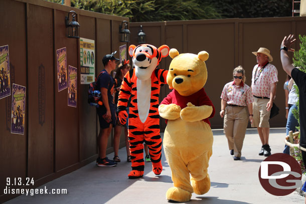 Winnie the Pooh and Tigger out for a stroll on their way to meet guests