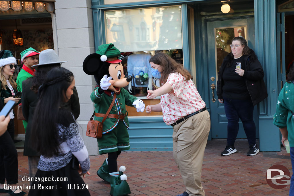 Mickey Mouse making his way out to take pictures with guests in his new Christmas outfit