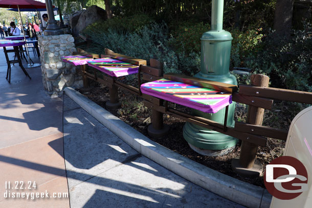 A few tables added to the fence along the performance corridor to spare guests from having to use a trashcan table.