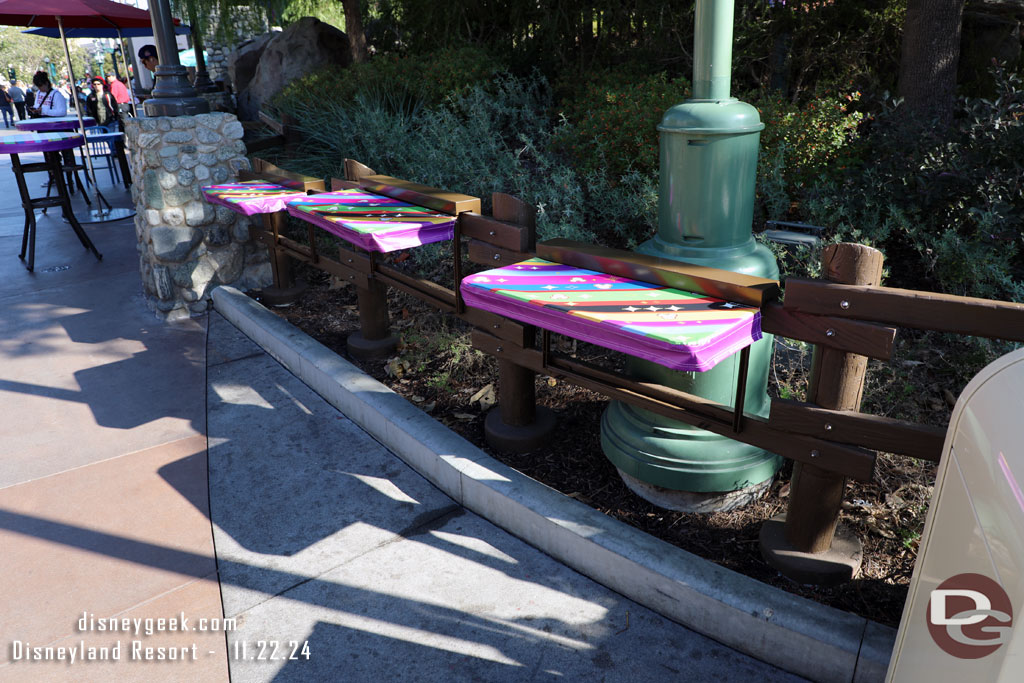 A few tables added to the fence along the performance corridor to spare guests from having to use a trashcan table.