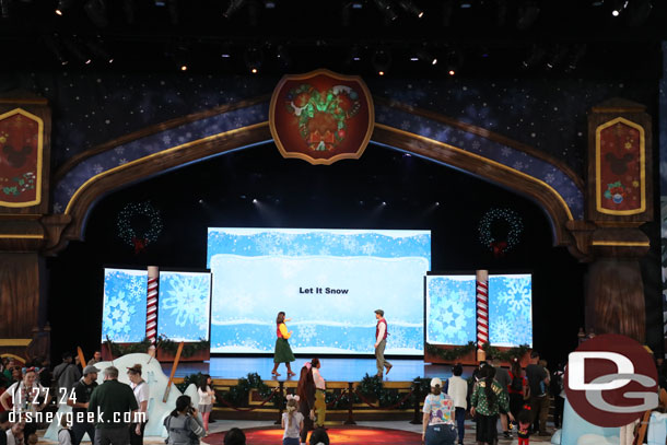 A couple of performers leading a sing along on the stage