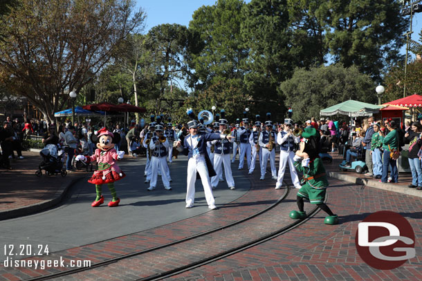 Disneyland Band led by Mickey and Minnie on a march to Town Square.