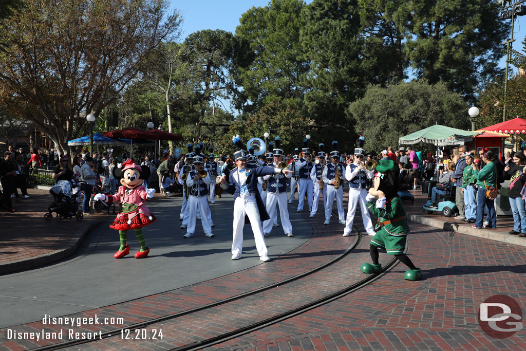 Disneyland Band led by Mickey and Minnie on a march to Town Square.