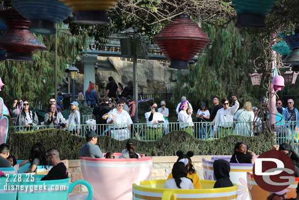 Cast Members cheering along the Mad Tea Party, not sure why.