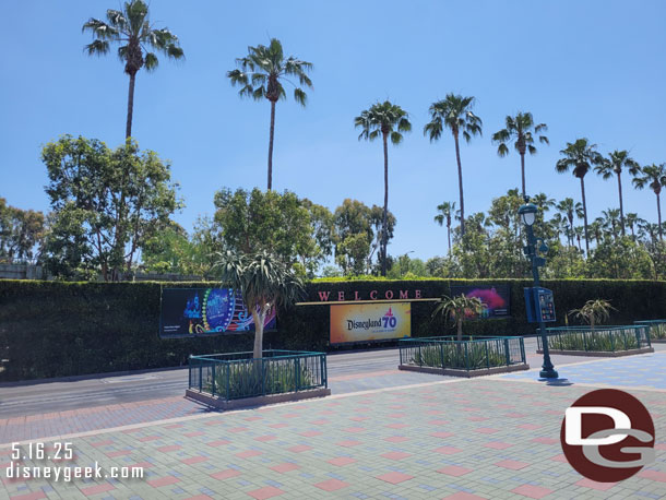 The tram stop billboards feature Disneyland 70th now