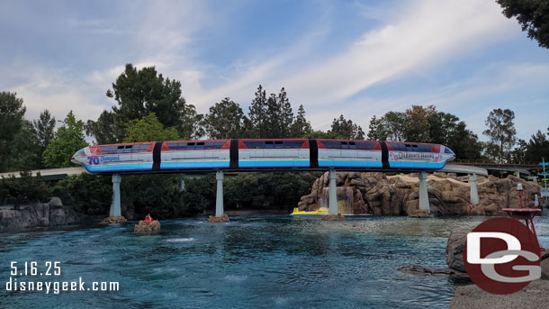 Monorail Red passing over the sub lagoon with its 70th anniversary wrap.