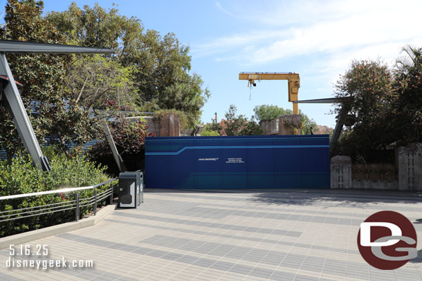 The Avengers Campus side of the walkway to Cars Land has a blue construction wall. 