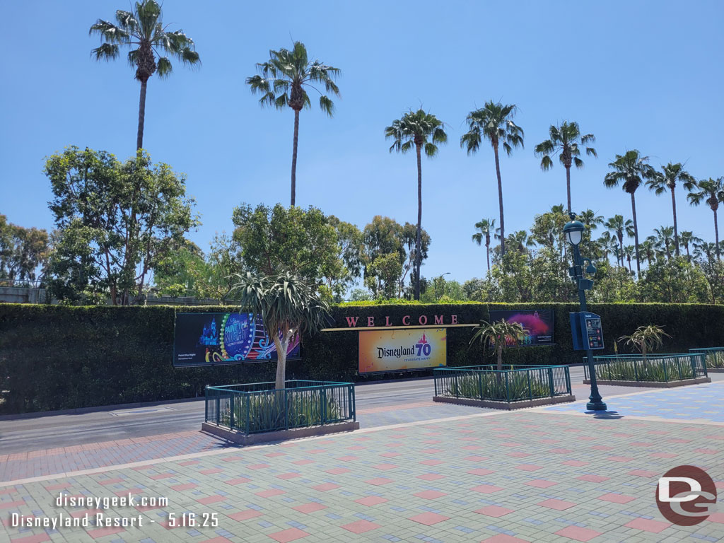 The tram stop billboards feature Disneyland 70th now
