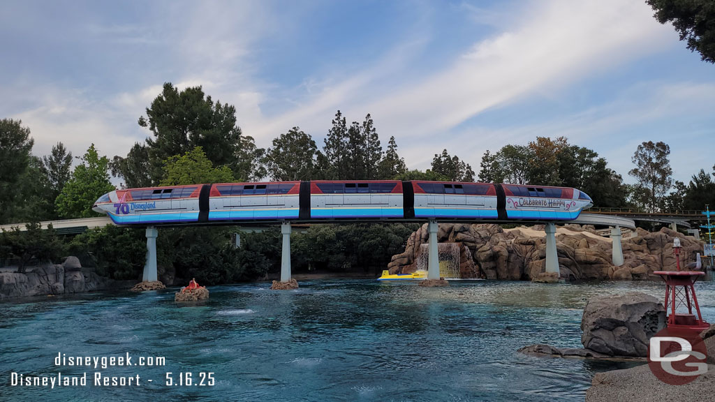 Monorail Red passing over the sub lagoon with its 70th anniversary wrap.