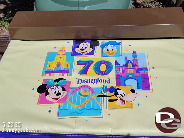 One of the Disneyland 70 covers on the tables on the railings along the performance corridor