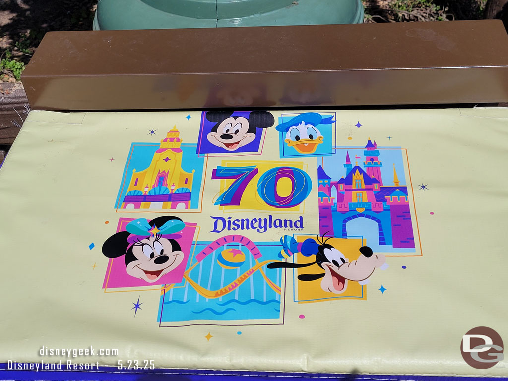One of the Disneyland 70 covers on the tables on the railings along the performance corridor
