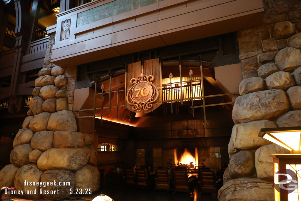 A Disneyland 70th logo over the fireplace area