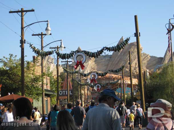 Cars inspired garland is strung across the street.