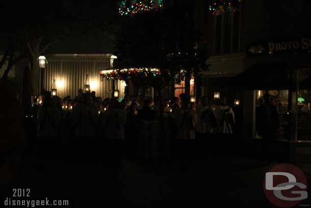 The procession starts at the end of Main Street USA.  The choir enters from backstage near the Baby Care Center.