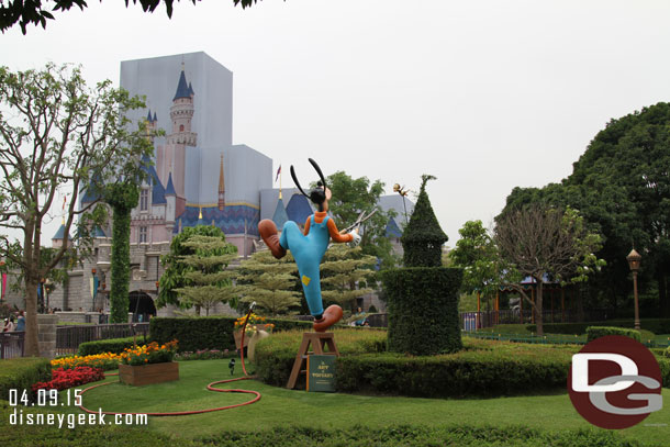 Goofy doing some landscaping in front of the castle