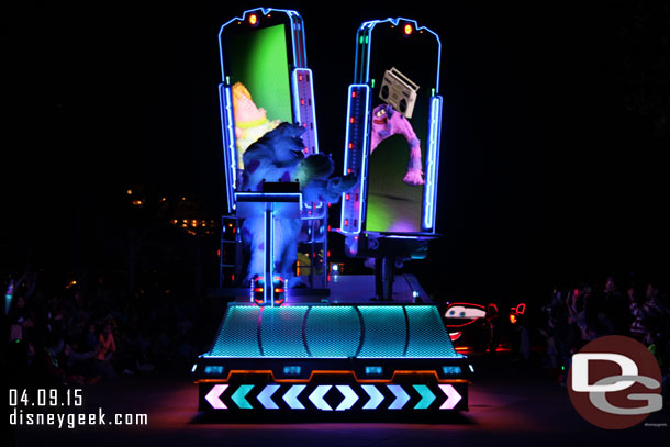 Sulley on the front of the float with giant doors the have video on them behind him.