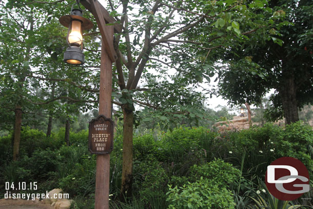 To the left of the main walkway leading from Adventureland on the stroller/wheelchair ramp is a meeting place.  I never saw anyone out there though.