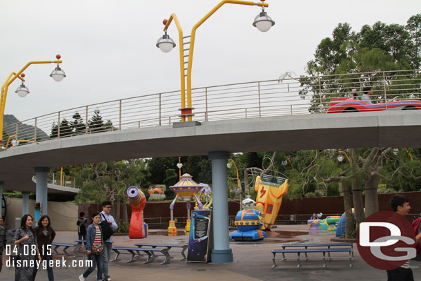 The Autopia in Hong Kong Disneyland is in Tomorrowland and has one track that has an elevated portion that extends out into the land.