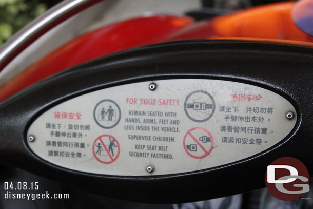 The safety sign in the car, in three languages.