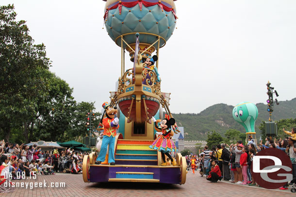 Mickey driving the balloon, Goofy, Minnie, Pluto and Donald below