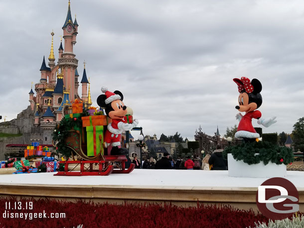 Mickey and Minnie in the hub with Sleeping Beauty Castle in the background.