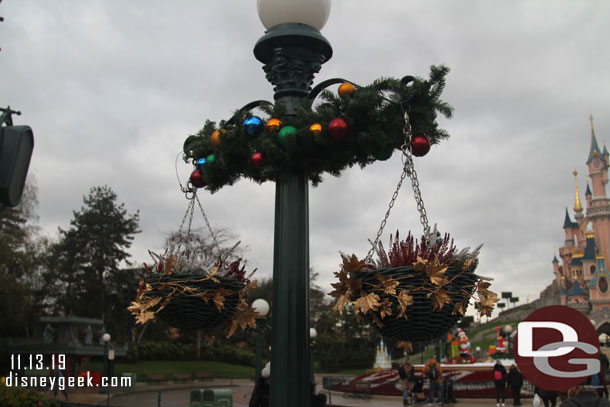 The lamp posts have hanging baskets and garland.