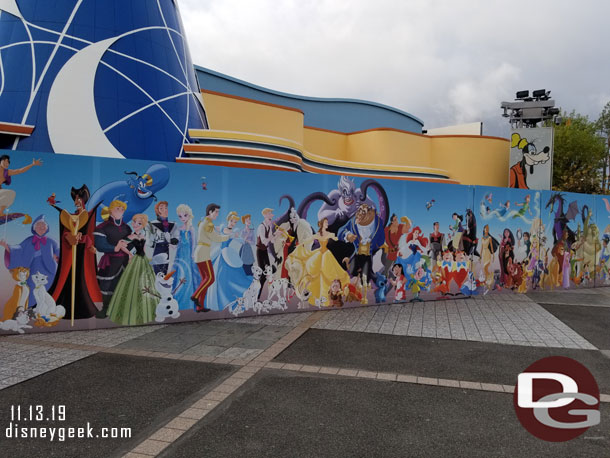 The construction wall features a lot of Disney characters.