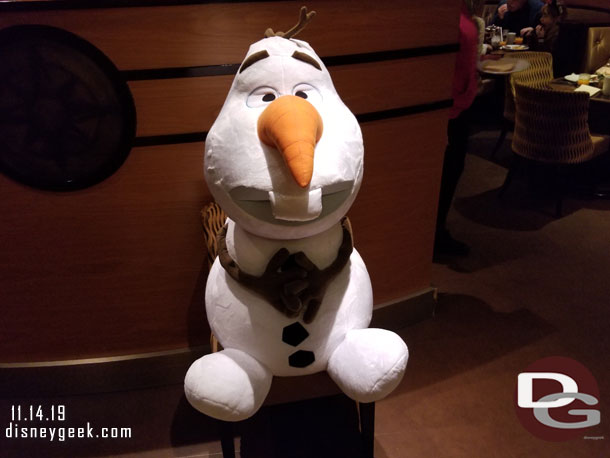 A large plush Olaf was set up by the entrance to greet guests and take photos.