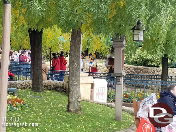 Pinocchio and Geppetto meeting guests nearby.