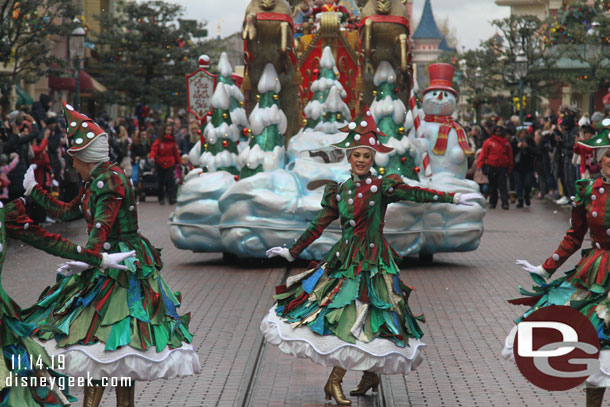 Dancing Christmas trees leading Santa.