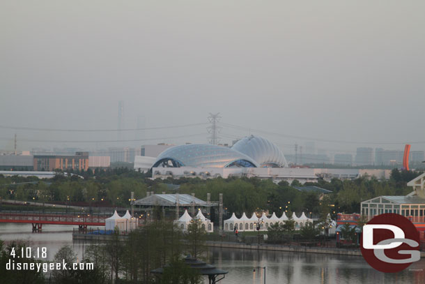 A little further left Tomorrowland with the Tron Canopy visible above the treeline and other buildings.  Beyond it through the haze in the distance you can just barely see the skyline for downtown Shanghai.