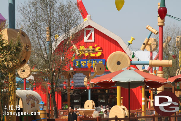 To the left is Woody's Roundup which is the same type of ride as Mater's in Cars Land.  In the background is Al's Toy Barn which is the gift shop.