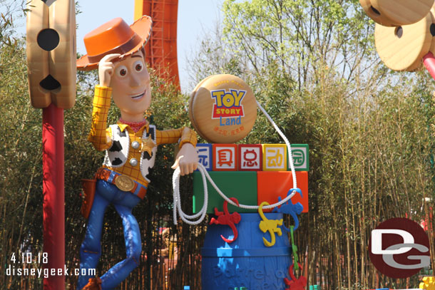 Woody by the land's entrance sign.