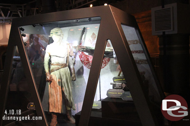 Some costumes and props in display cases.