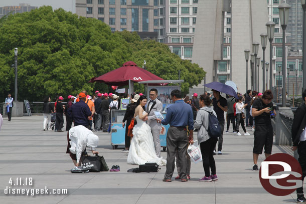 A couple having wedding photos taken with the sky scrappers in the background.