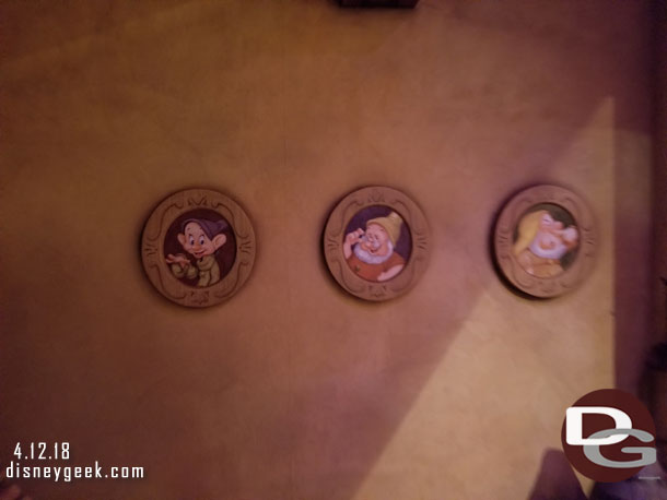 The dwarfs pictures line the cottage wall in the next scene.