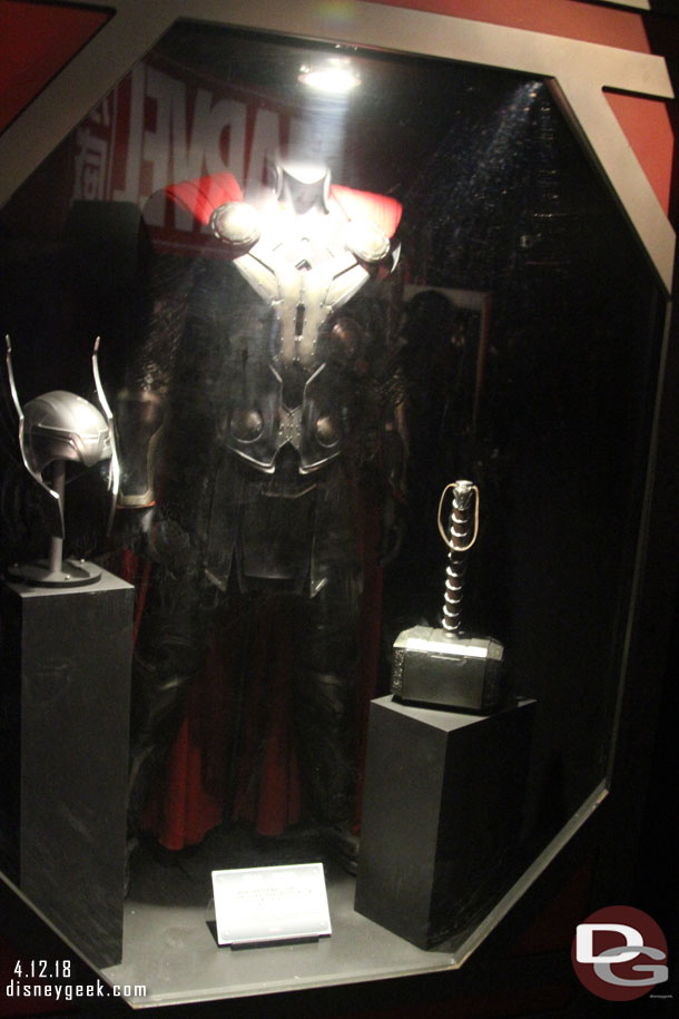 Some costumes and props in display cases.